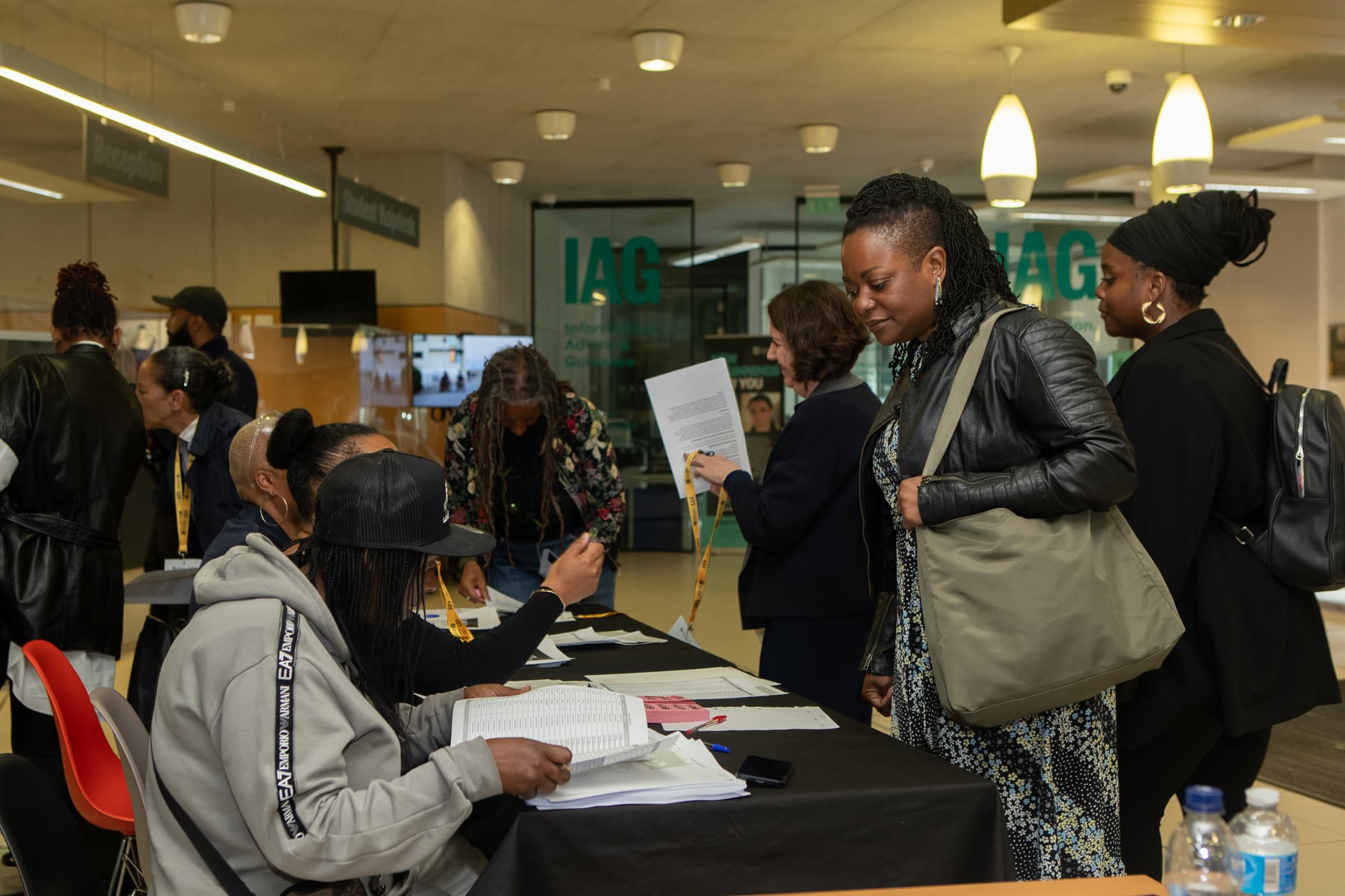 Attendees collecting lanyards and signing in at the registration desk of an APA conference